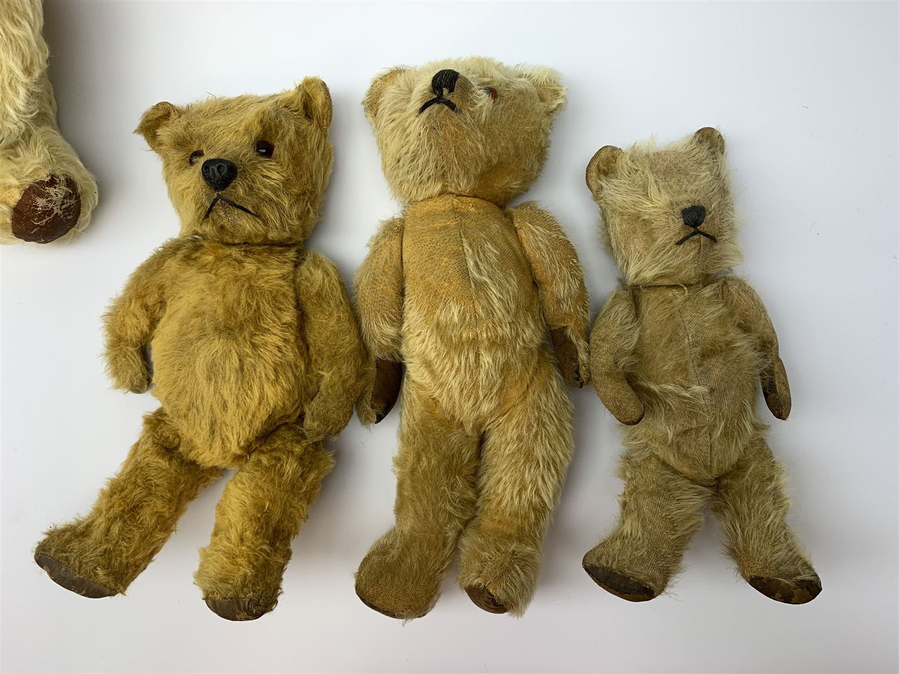 Five English teddy bears c1930s-50s comprising Chad Valley with swivel jointed head, glass eyes, vertically stitched nose and mouth and jointed limbs with rexine pads H16