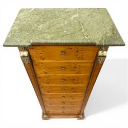 Neoclassical marble and inlaid figured maple wood tall chest, green marble inverted-breakfront top over eight long drawers, flanked by square tapering pilasters with gilt metal female bust and anthemion leaf capitals and brass feet terminals, the skirted base with applied Medusa gilt metal mounts, on compressed bun feet