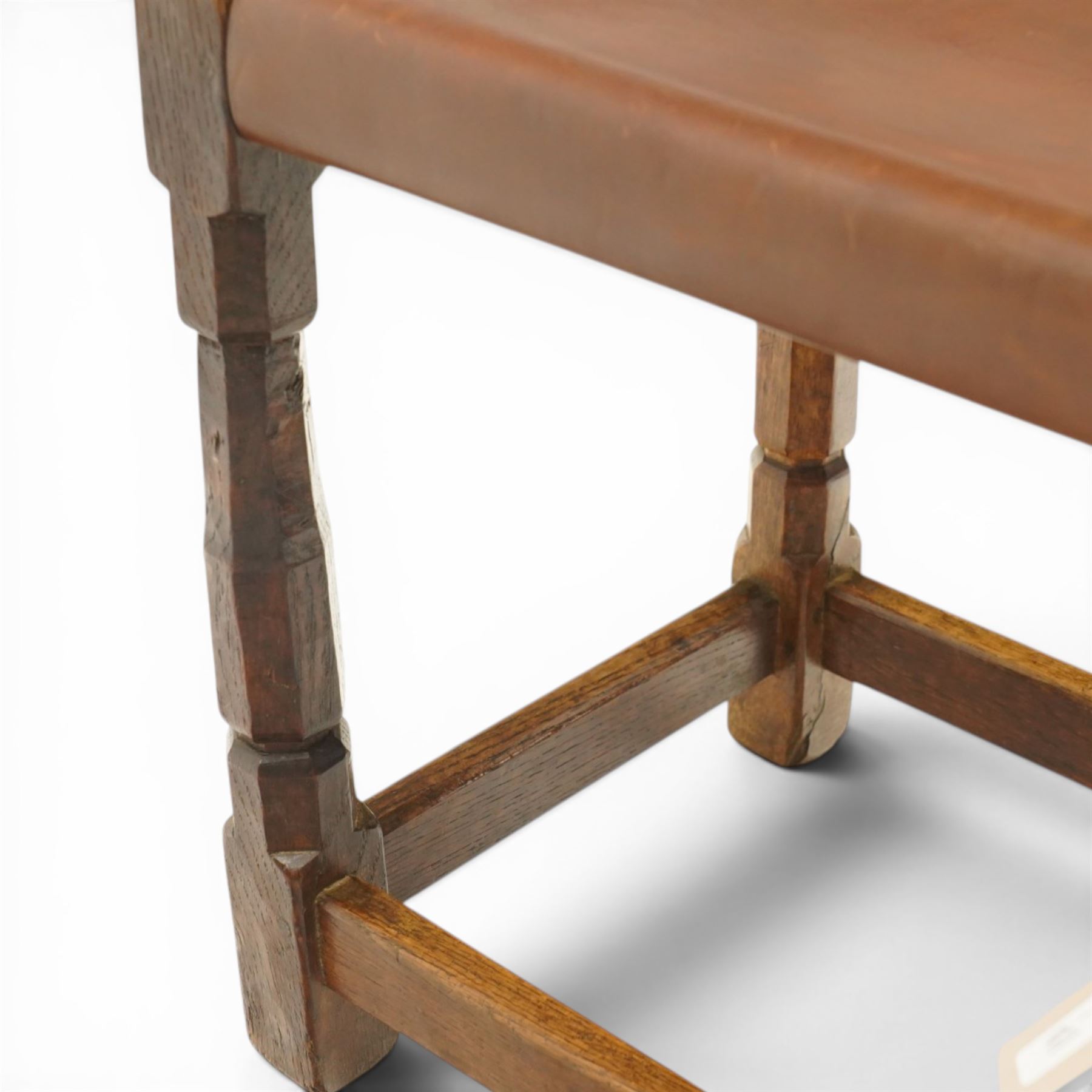 Mouseman - 1940s dark oak dressing table stool, the rectangular top with deep-tan leather seat, raised on octagonal supports united by box stretcher, with carved mouse signature, by the workshop of Robert Thompson of Kilburn