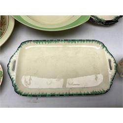 Clarice Cliff for Newport Pottery Corolla pattern tea and dinner wares, comprising triangular bowl, four side plates, two shallow bowls and teacup (a/f), together with a Clarice Cliff Wilkinson twin handled soup bowl and unassociated saucer both decorated with pink and yellow flowers, together with other mid century ceramics comprising Parrott and Company Coronet Ware, and Royal Staffordshire AJ. Wilkinson Ltd dinner wares