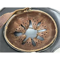 WW2 German steel helmet painted in undecaled Luftwaffe bluey grey with leather liner and chin strap stamped '58', the skirt impressed '1250'