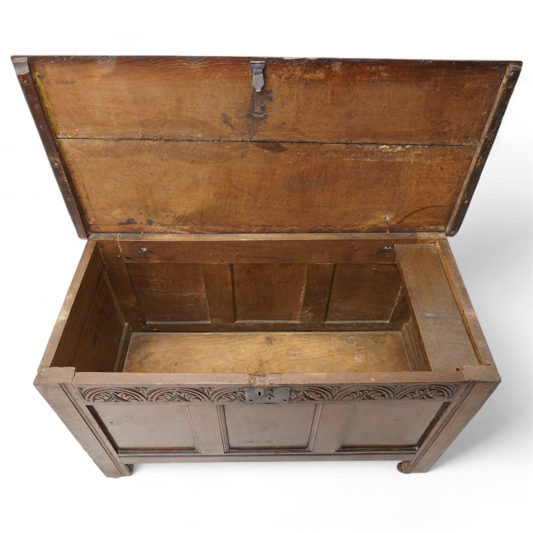 18th century oak blanket box, moulded rectangular hinged lid over lunette carved frieze rail and panelled front, moulded frame and panelled sides fitted with carrying handles, on stile supports
