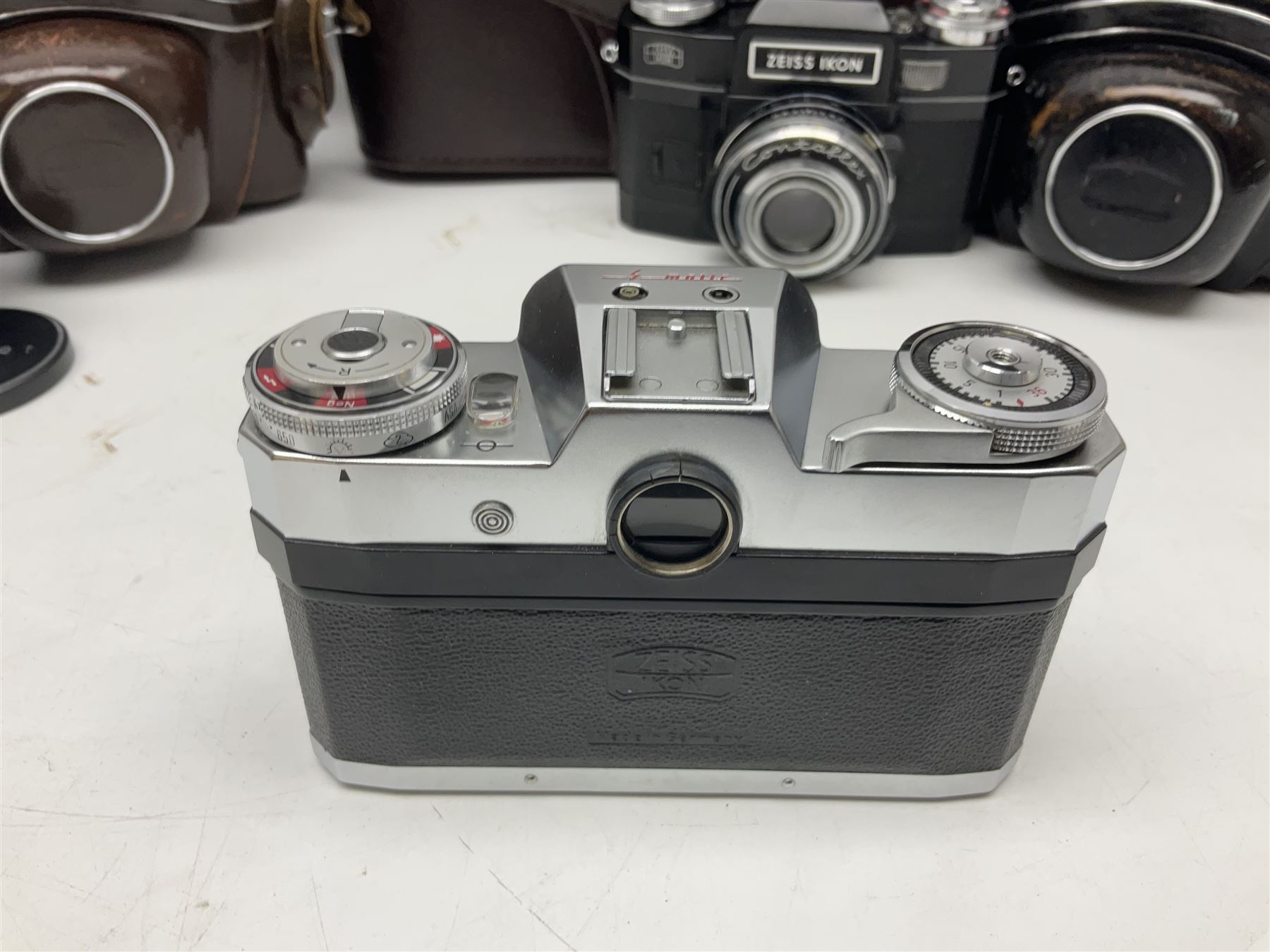 Four Zeiss Ikon camera bodies, to include, Contaflex Super B camera body, serial no. B31591, with 'Carl Zeiss Tessar 2.8/50 lens, serial no.3425553, Contaflex Super BC camera body, serial no. P81728, with 'Carl Zeiss Tessar 2.8/50' lens, serial no 4822280, etc, together with three cased lenses; 'Carl Zeiss Pro-Tessar 1:4 f=115mm' lens, serial no 3734740, 'Carl Zeiss Pr-Tessar 1:3.2 f=85mm' lens, serial no. 3647764 and 'Carl Zeiss Pr-Tessar 1:3.2 f=35mm' lens, and other Zeiss Ikon equipment 