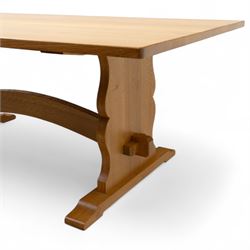 Unicornman - Yorkshire oak rectangular refectory style dining table by Coxwold cabinet maker Geoff Gell, rectangular top above trestle form base with broad scrolling outward outline, and heavy arched stretcher with Unicornman carved motif, traditional mortice and tenon pegged joints between the uprights