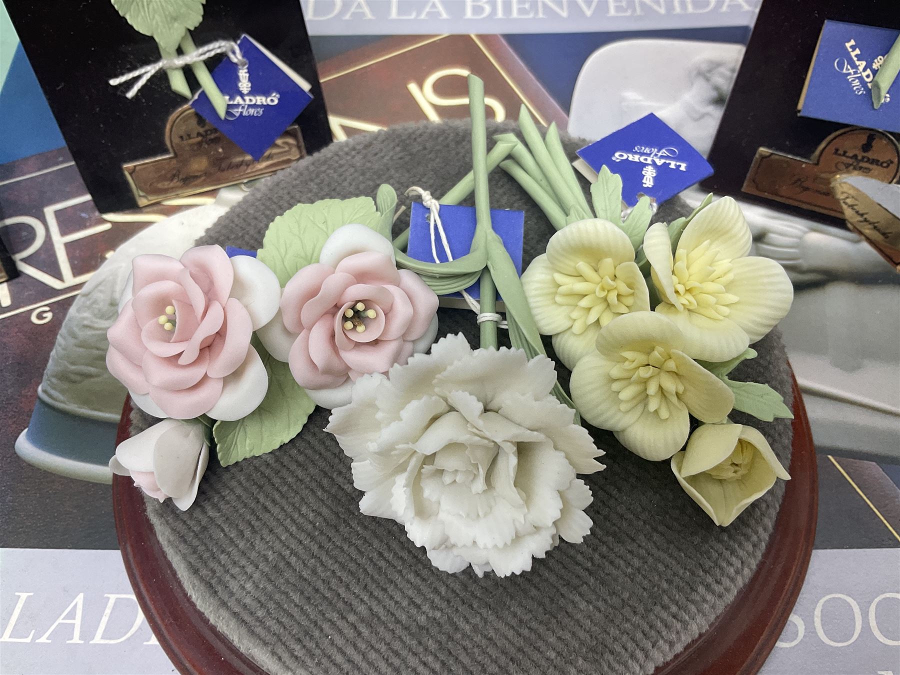 Seven Lladro flowers, comprising Japanese Camelia on base no 5181, Yellow Begonia on base no 5186, Miniature Begonia on base no 5188, Chrysanthemum on base no 5189, California Poppy no 5190.B, Miniature Begonia 5188.B and White Carnation no 5184.B, together with Lladro Spanish Joining pack with 17616 Winter Bell, Additional Lladro parasols and flowers etc 