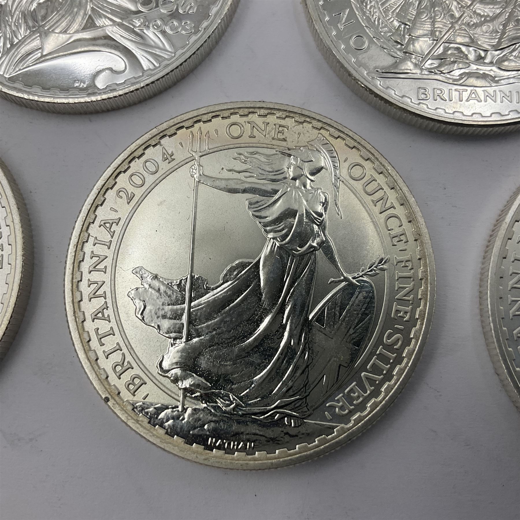 Five Queen Elizabeth II United Kingdom one ounce fine silver Britannia two pound coins dated 2002, 2003, 2004, 2005 and 2006