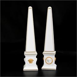 Pair of Rosenthal Versace Gorgona obelisks, each with relief moulded Medusa masks and gilt...