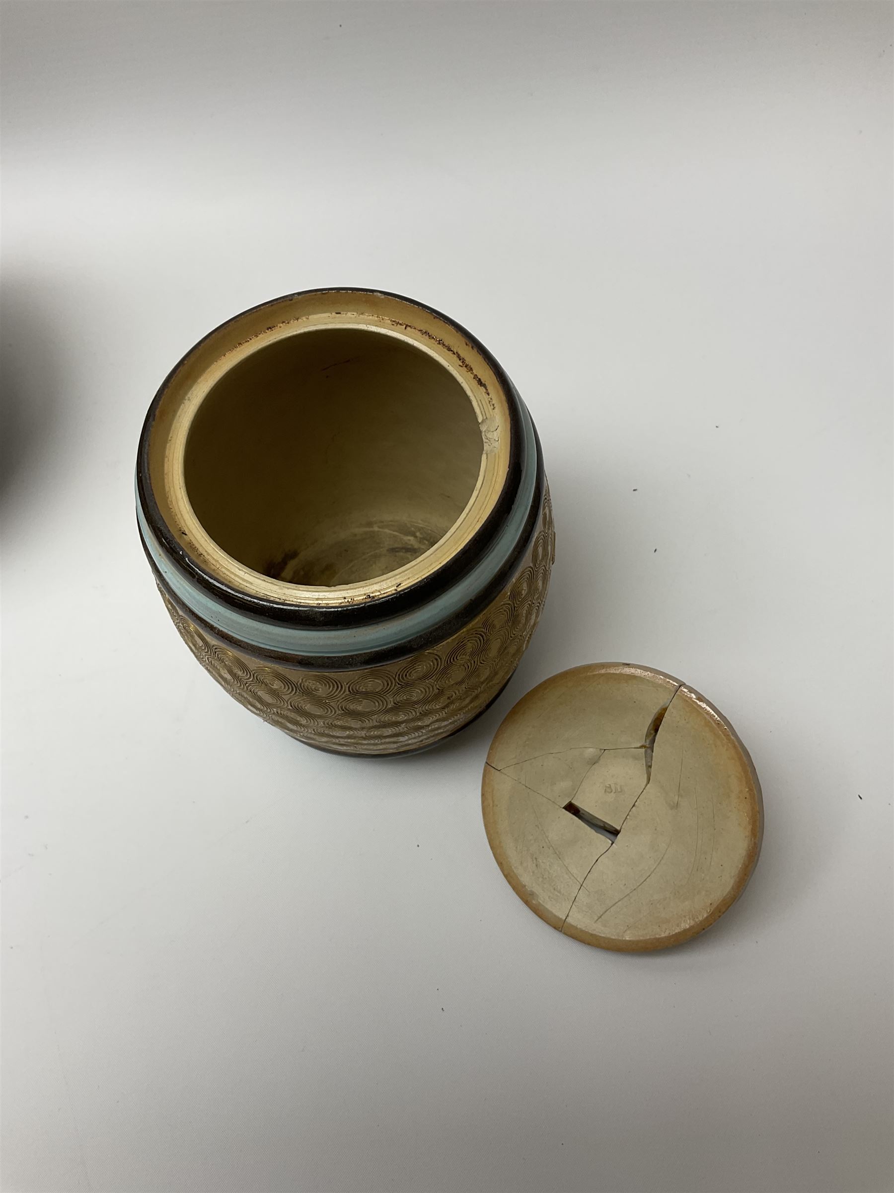 A group of Doulton Lambeth and Royal Doulton tobacco jars, to include examples with relief moulded foliate decoration, each with impressed marks and markers monograms beneath. 