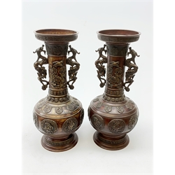 Pair of large Japanese bronze vases, of baluster form with tall neck and flared rim, having twin dragon modelled handles, the necks decorated with birds and blossoming branches, the bodies with zoomorphic panels, further detailed with stylised bands throughout, H48cm