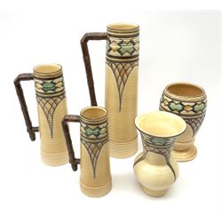 Five pieces of Royal Cauldon tube lined ware, comprising three graduated handled jugs, and two vases, with geometric decoration, largest jug H31cm. 