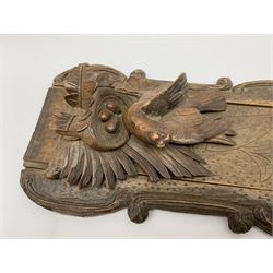 Late 19th/early 20th century Black Forest style book slide, the supports carved with birds upon a nest containing eggs amidst foliage, retracted L45.5cm
