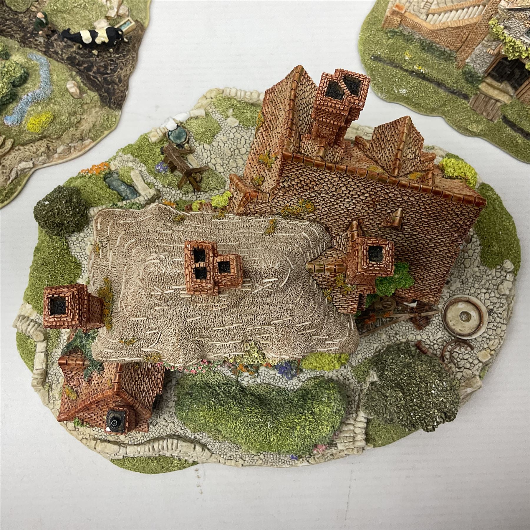 Three Lilliput lanes, comprising Oakwood Smithy, Anne of Cleves and Bluebell Farm, all with deeds and original boxes 