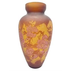 Art Nouveau style glass vase, in the style of Galle, the tapering body decorated with trailing red and pink foliage on a yellow ground, H33cm