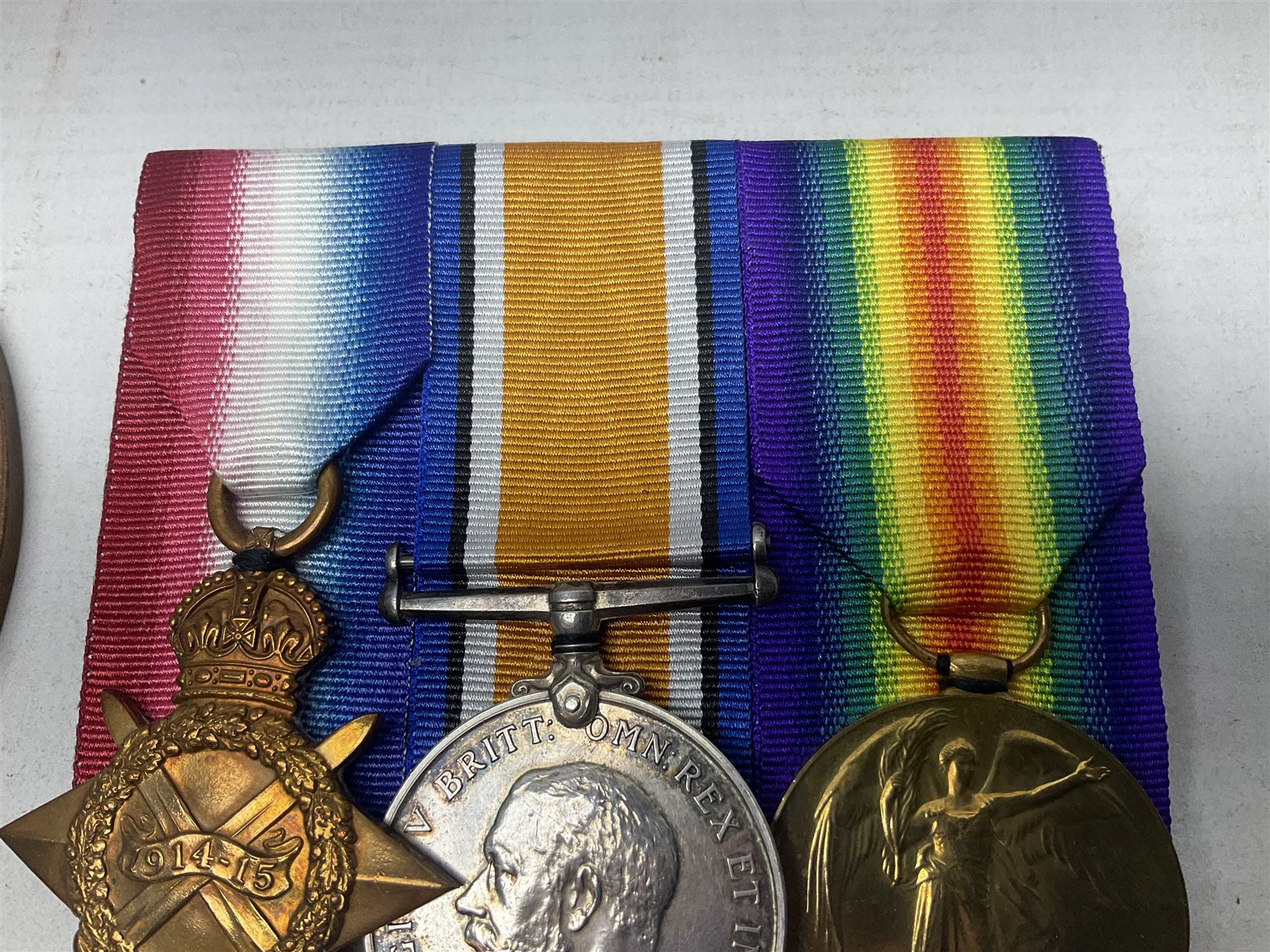 WW1 KIA group of three medals comprising British War Medal, 1914-15 Star and Victory Medal together with bronze Memorial Plaque named to G-13 Pte. F.G. Hodges R. Suss. R.; with ribbons; displayed on modern board for wearing; some biographical details