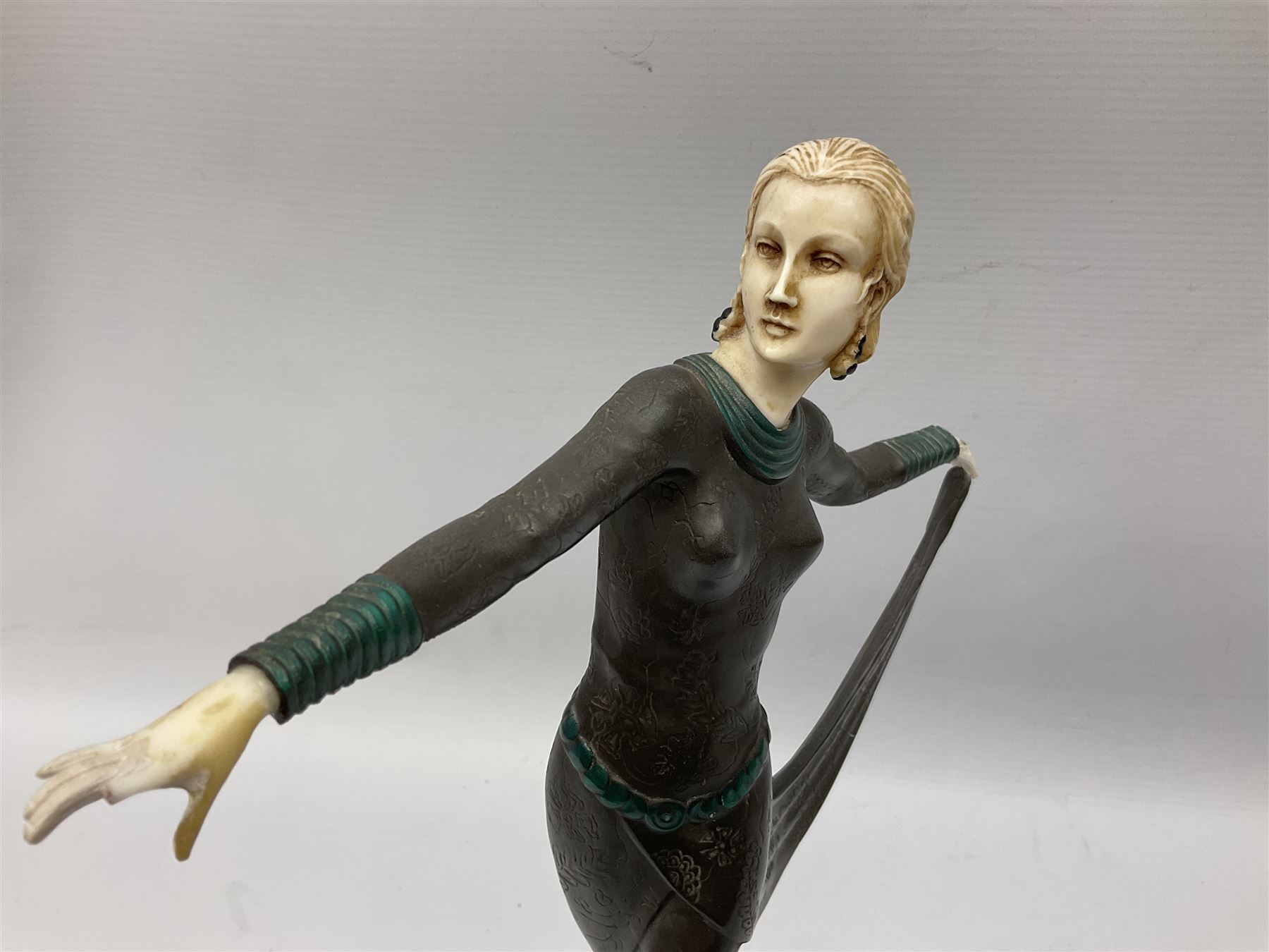 Art Deco style bronze, after Josef Lorenzl, modelled as a dancing lady with outstretched arms, with resin head and hands, raised upon marble effect base, signed to base, H38cm