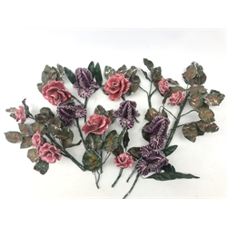  A small collection of ceramic flowers, in the form of pink roses and purple buds, with painted tin leaves.   