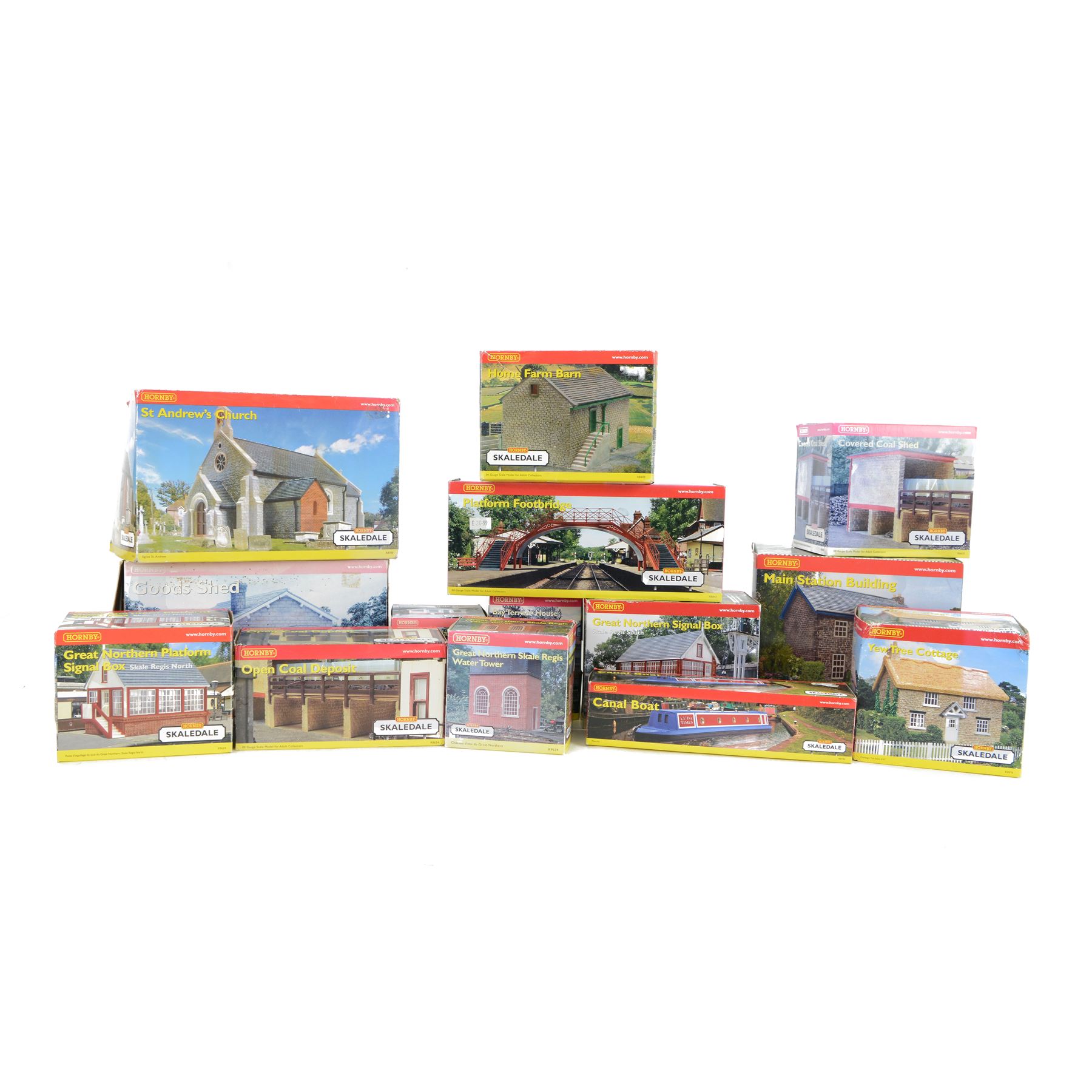 Fourteen Hornby Skaledale 00 gauge model railway trackside buildings, comprising R8718 Lower Skaledale Shelter, R9722 Bay Terrace House, R8635 Goods Shed, R9639 Great Northern Skale Regis Water Tower, R8634 Open Coal Deposit, R8633 Covered Coal Shed, R8628 Main Station Building, R8746 Canal Boat, R8976 Yew Tree Cottage, R8641 Platform Footbridge, R8602 Home Farm Barn, R9634 Great Northern Platform Signal Box, R8700 St Andrews Church and R9635 Great Northern Signal Box, all boxed