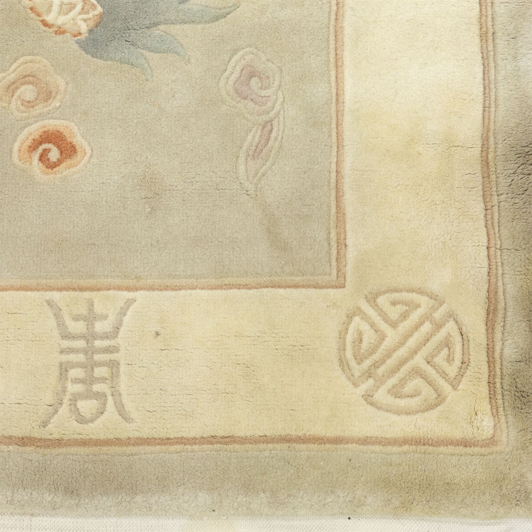Chinese wool rug, the pale grey central field decorated with two stylised dragons, flaming pearls and cloud scrolls, within a cream border of shou medallions and geometric motifs, with cotton fringe ends