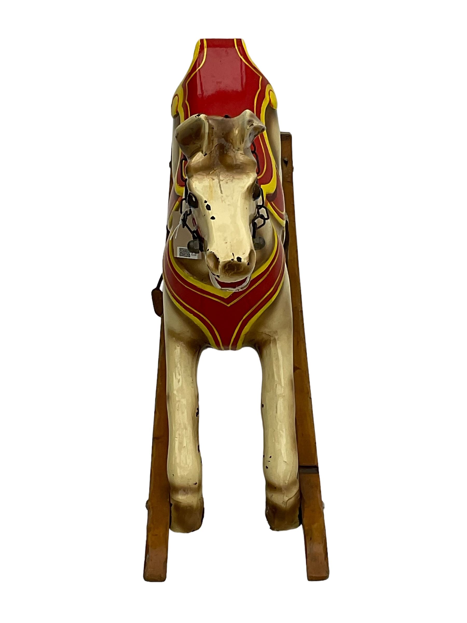 20th century rocking horse, painted body, glass eyes, metal stirrups and chain, wooden bow rocker
