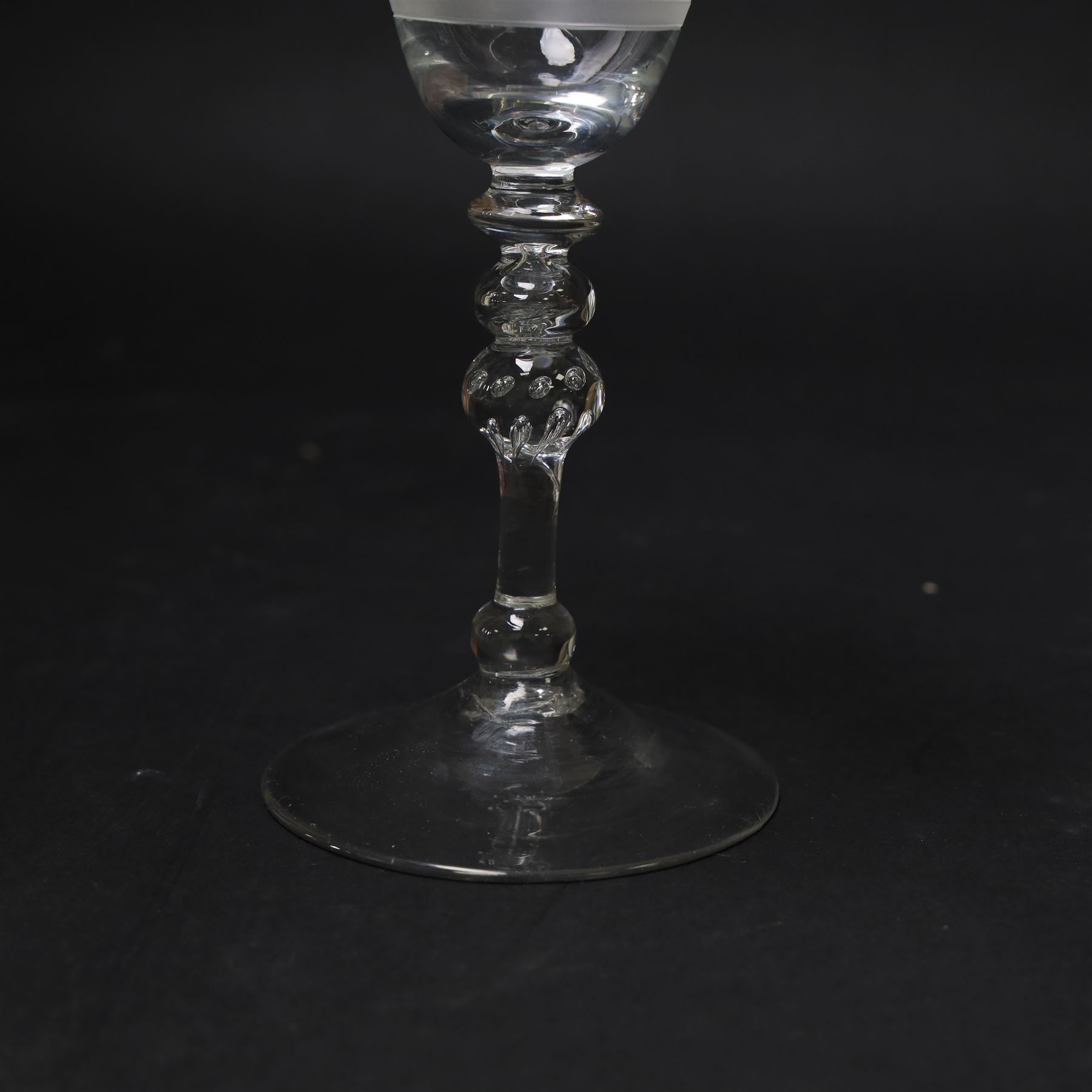 Dutch engraved Newcastle light baluster glass, circa 1760, the funnel bowl engraved with a two storey country house and church flanked by trees, beneath the inscription ‘T WELVAREN VAN LANDT ENKERK’ (The prosperity of the Country and Church), upon a multi knopped stem with beaded knop and basal knop, over conical foot, H18cm



