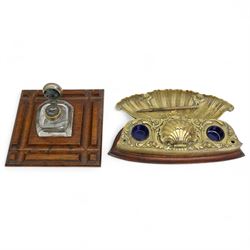 Late 19th/20th century inkwells, one brass example with shell decoration and blue glass li...