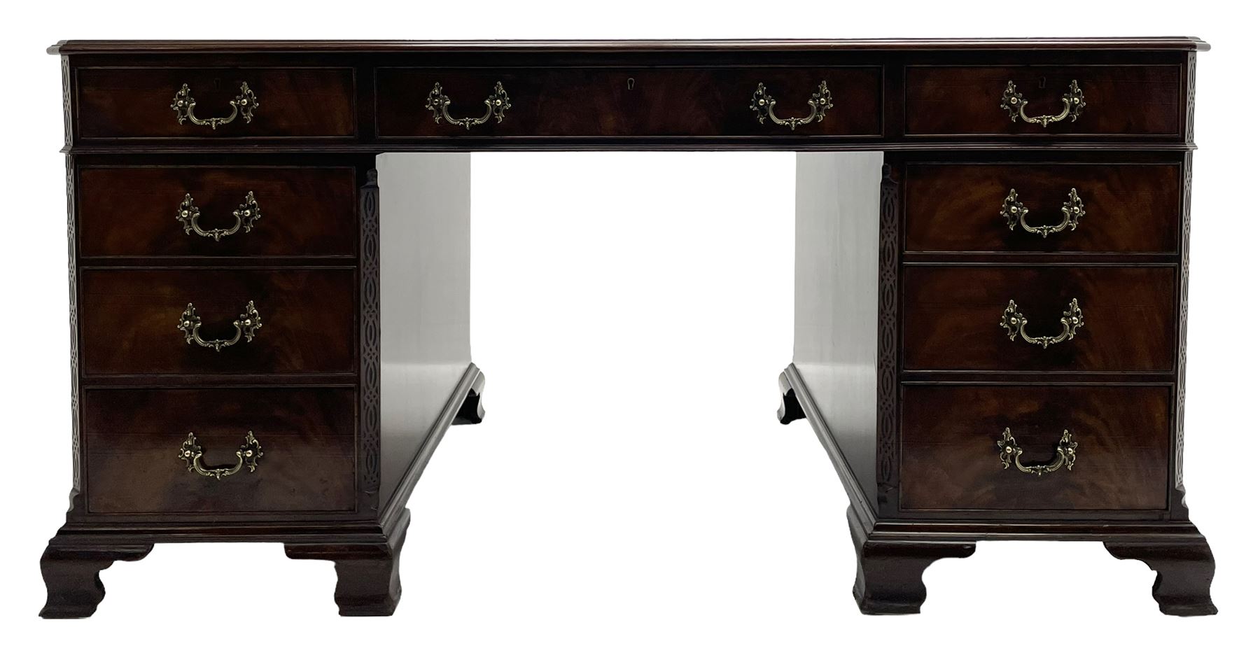 Large Georgian design mahogany twin pedestal partner's desk, moulded rectangular top with canted corners and inset leather writing surface, fitted with nine drawers and two cupboards, the pedestals with canted uprights decorated with blind fretwork, on ogee bracket feet