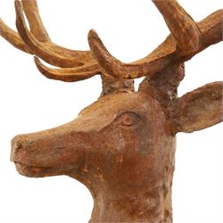Pair of cast iron stags, upon a on moulded rocky plinth, standing alert 