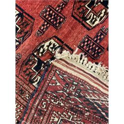 Bokhara red ground rug, decorated with two rows of Gul motifs, the border with geometric guard bands decorated with stylised plant motifs