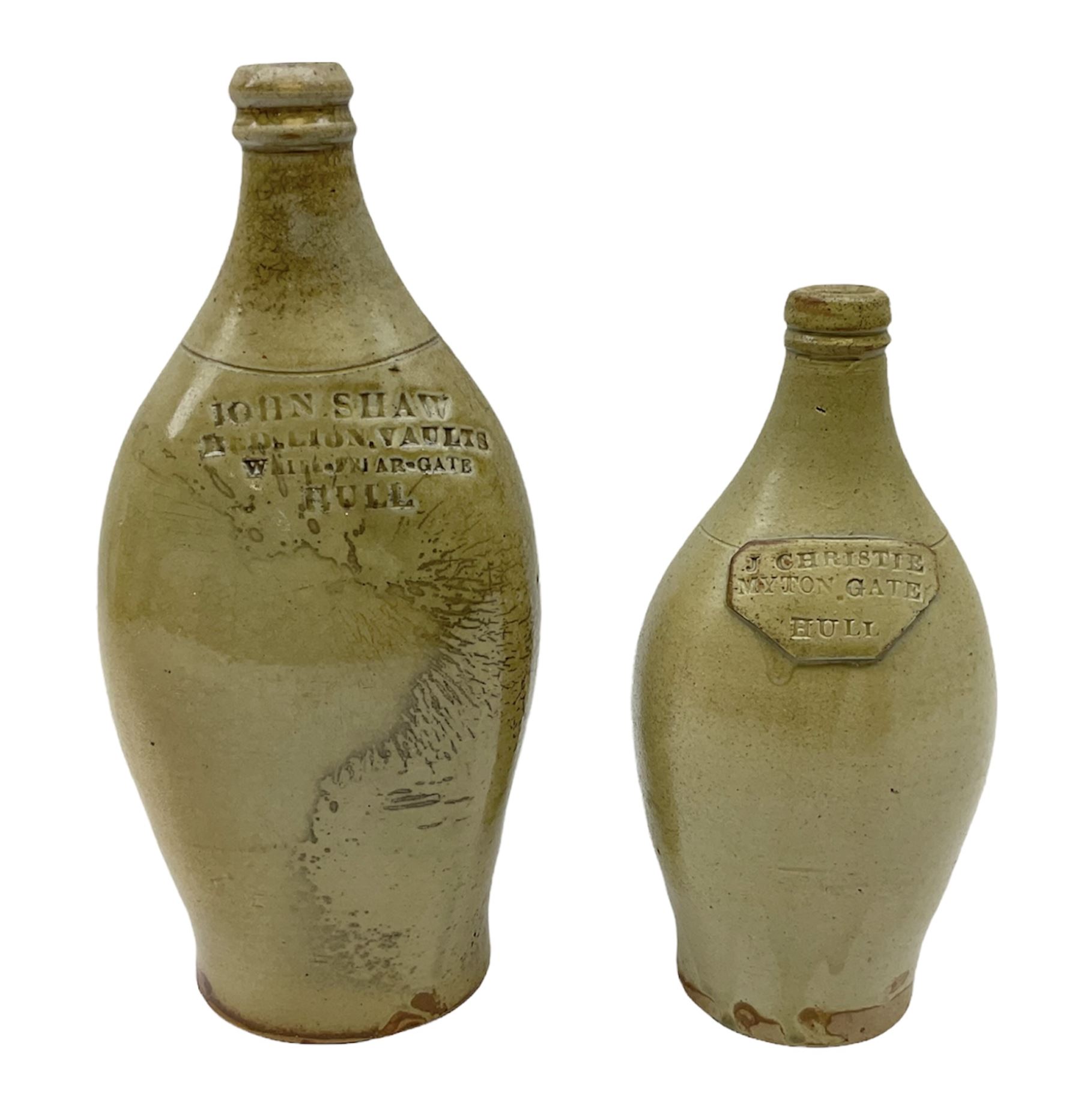  19th century salt glazed stoneware gin bottle impressed John Shaw, Red Lion Vaults, Whitefriargate, Hull of bulbous oval form H27cm and another with impressed label for J. Christie Mytongate Hull (2)  