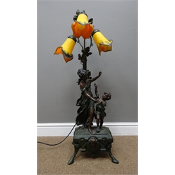  Large 1970's classical style bronzed finish table lamp, decorated with a mother and child, three mottled glass flower shaped shades on rectangular base supported by four splayed legs & hoof feet, H105cm   