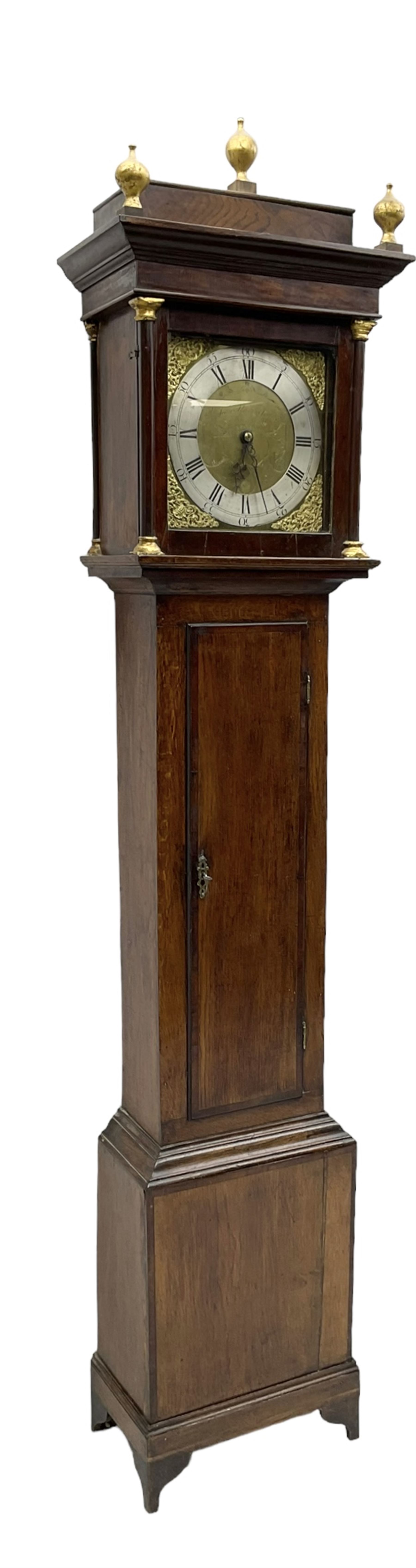 John Kemp of Yoxford (Suffolk) - 18th century oak 30 hour longcase clock c1770, with a later box top and finials, square hood door with attached pilasters and gesso capitals, long flat topped trunk door with a rectangular plinth and bracket feet, brass dial with cast spandrels and engraved dial centre, silvered chapter ring with Roman numerals and five minute Arabic's, with matching steel hands, birdcage chain driven movement with a recoil anchor escapement and count wheel striking. With weight and pendulum.

