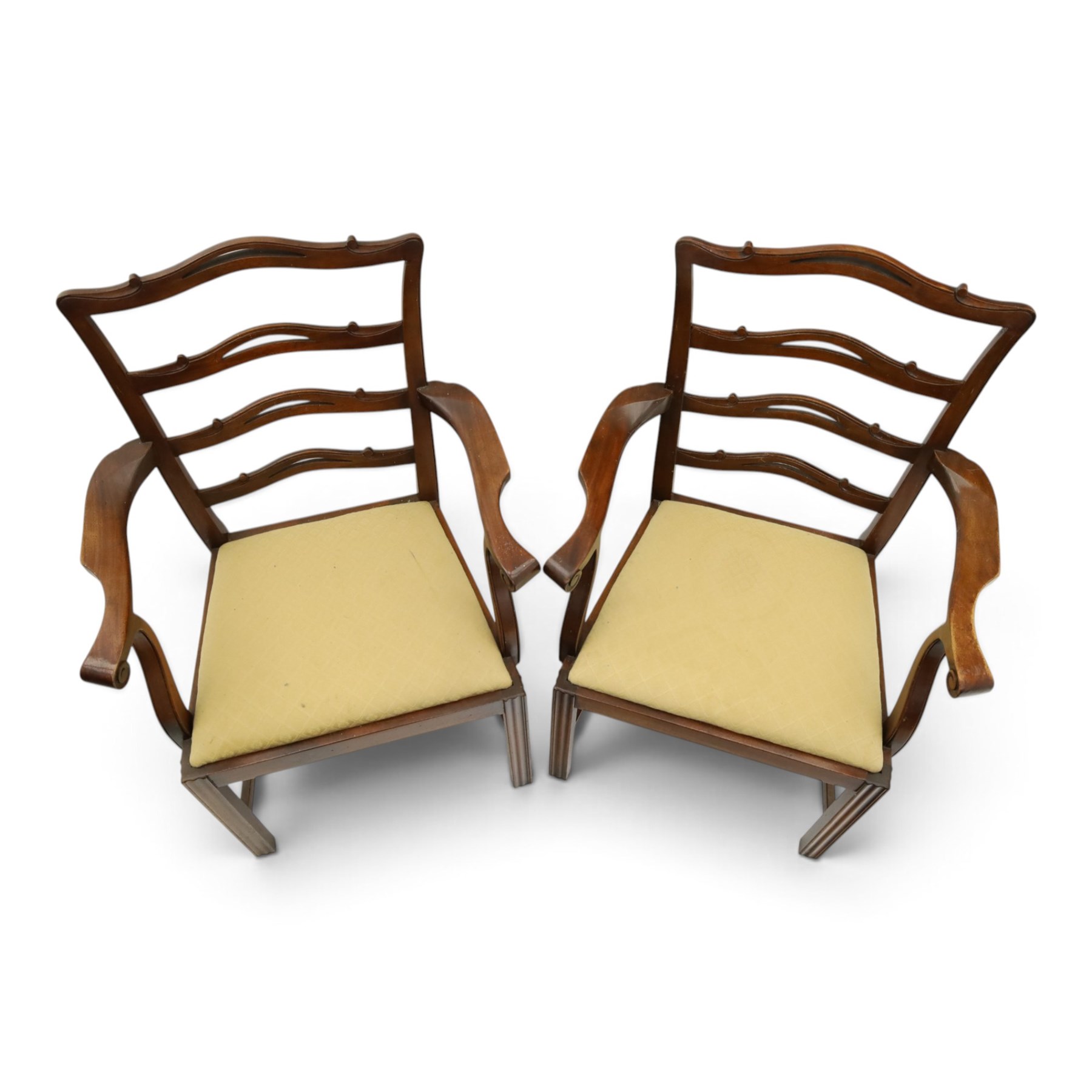 Pair of Georgian design Chippendale style mahogany elbow chairs, the pierced and waived ribbon ladder-back over scrolled arm terminals and yellow drop-in seats, on moulded and chamfered square supports