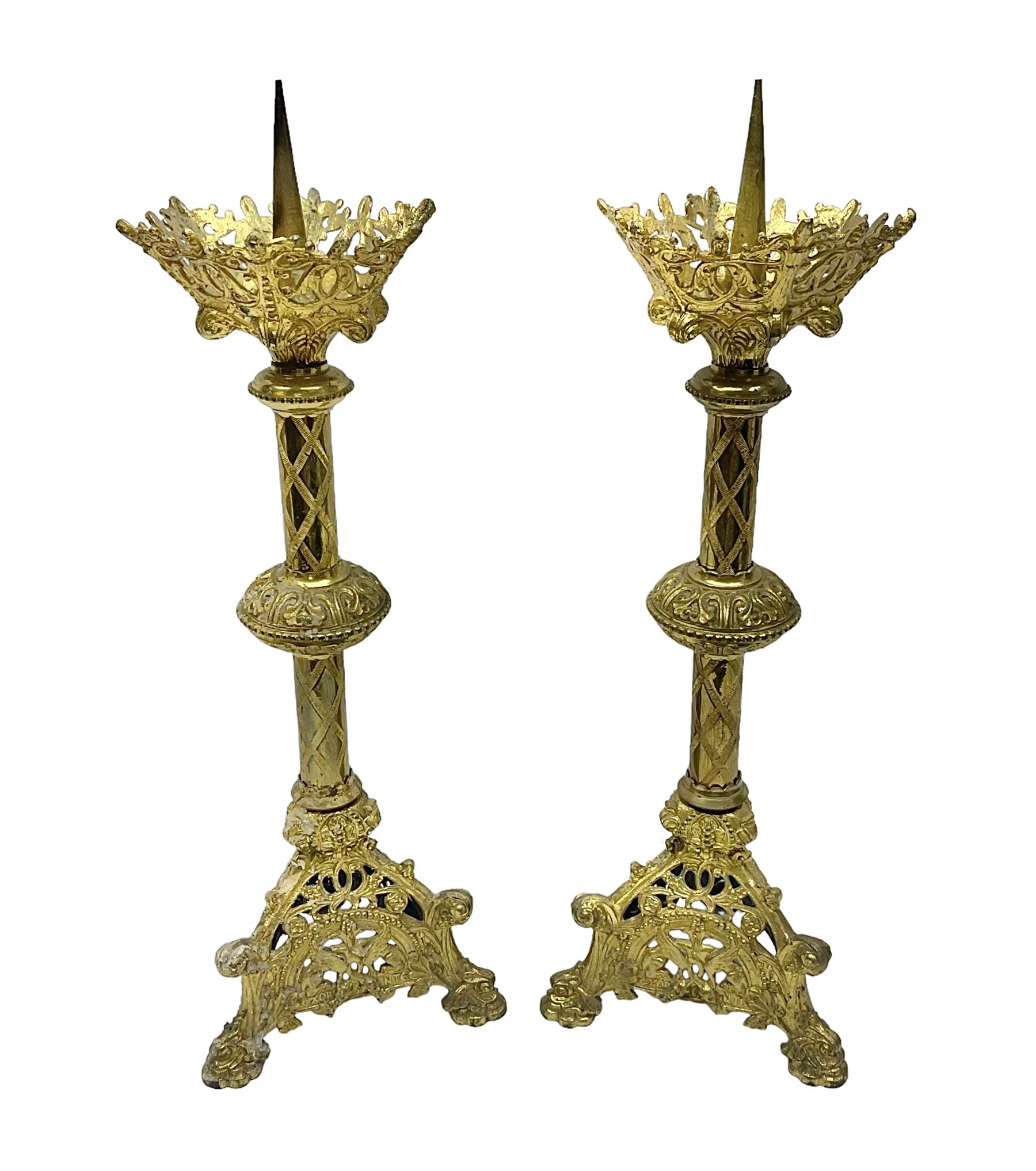 Pair of gilt metal pricket candlesticks, with applied decoration on knopt stems and triform bases, H47cm