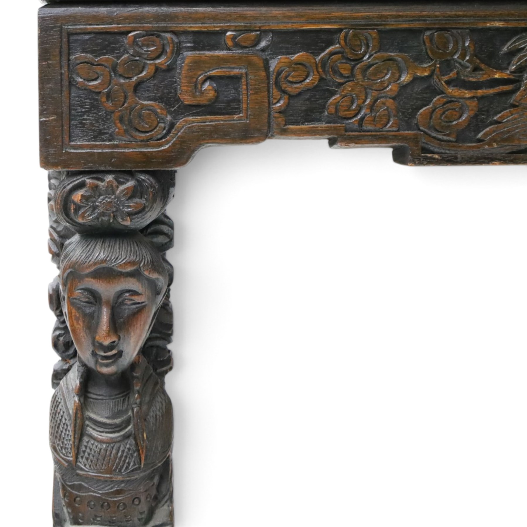 Early 20th century Chinese export carved hardwood writing bureau, the sloped fall front deeply carved with a narrative figural scene beneath pine and prunus trees, above a pair of rectangular carved panels, the shaped crest rail with entwined dragons, interior fitted with pigeonholes and a central drawer, on figural front supports with shaped stretcher