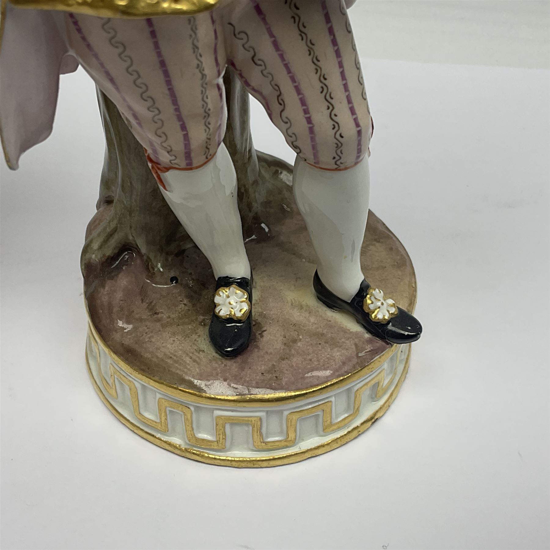 Pair of late 19th/early 20th Century Meissen figures, modelled as flower sellers, after the original by Michel Victor Acier, she holding basket of flowers, he holding flowers in his hat, each with underglaze cross swords mark beneath, tallest H16.5cm