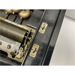 Large late 19th century Swiss bells-in-sight musical box with 27.5cm cylinder playing eight airs on a 27cm two-piece comb with seventy-seven teeth and six graduated engraved saucer bells with strike/silent facility; in crossbanded rosewood and ebonised case, the front and hinged lid inlaid with musical trophies, opening to reveal a song card under the lid and hinged glazed cover to the movement; serial no.7539 L53cm