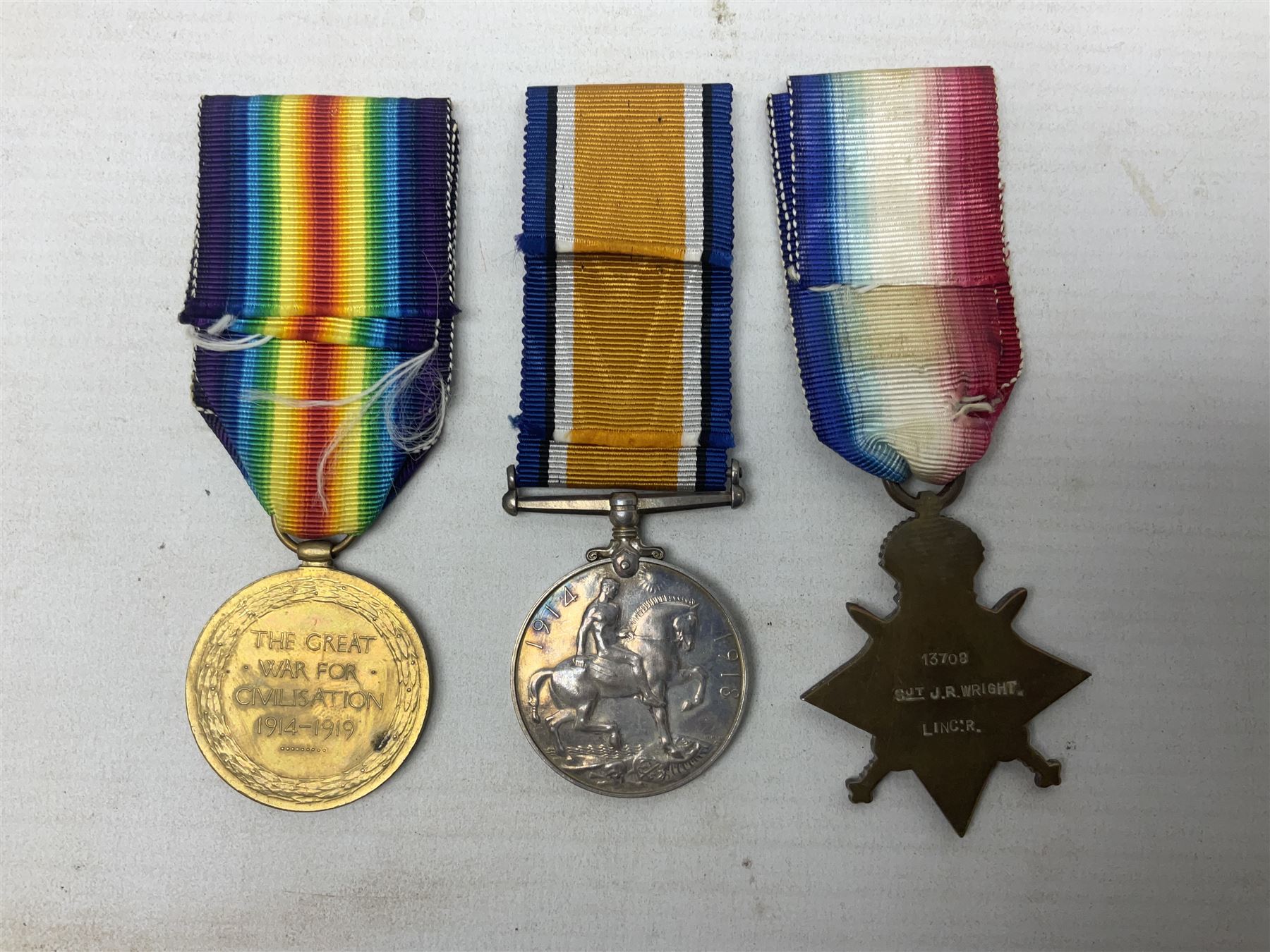 WW1 trio of medals comprising British War Medal, 1914-15 Star and Victory Medal awarded to 13708 Sjt. J.R. Wright Linc. R.; all with ribbons; some biographical details