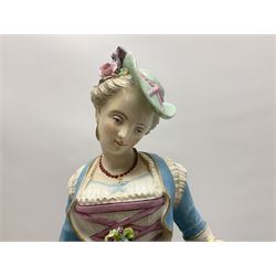 Large pair of late 19th century Continental figures in the Meissen style, modelled as a gardener and companion in 18th century dress, holding baskets of flowers and posies, each upon naturalistically modelled floral encrusted square base with scroll moulded sides, with underglaze blue cross sword type marks beneath, tallest example H49cm