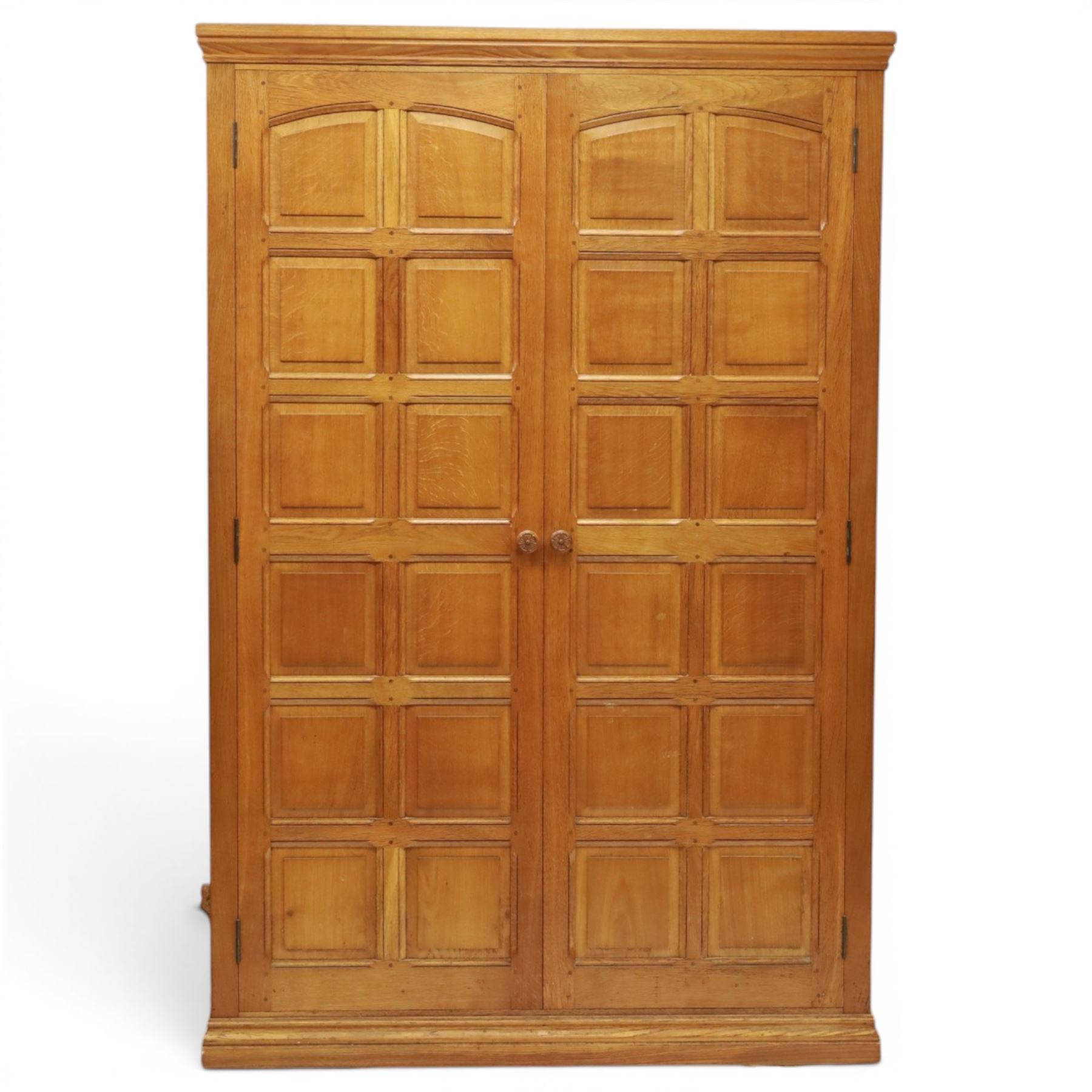 Beaverman - oak double wardrobe, enclosed by twin multi-panelled doors, Yorkshire Rose carved handles, the interior fitted with shelf and hanging rail, with signature carved beaver, by Colin Almack of Sutton, near Thirsk