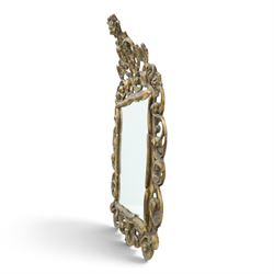 Rococo style gilt wall mirror, the shaped rectangular bevelled plate within a pierced frame of scrolling acanthus leaves, surmounted by a foliate crest