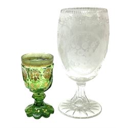 19th century presentation glass goblet, the bowl decorated with acid etched floral sprays and foliate motifs, the circular spreading foot with star cut base, together with a bohemian green glass goblet, with faceted bowl raised  on faceted support and petal shaped base with gilt floral decoration throughout, tallest H25cm