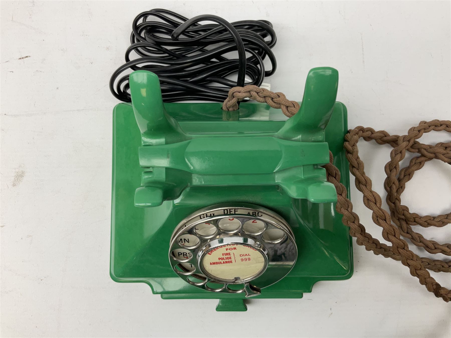 Jade green Bakelite telephone, of pyramid form with alphabet dial, brown braided handset cord and a base draw