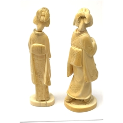 Two Japanese carved ivory okimons, each modelled as a geisha, each approximately H15cm. 