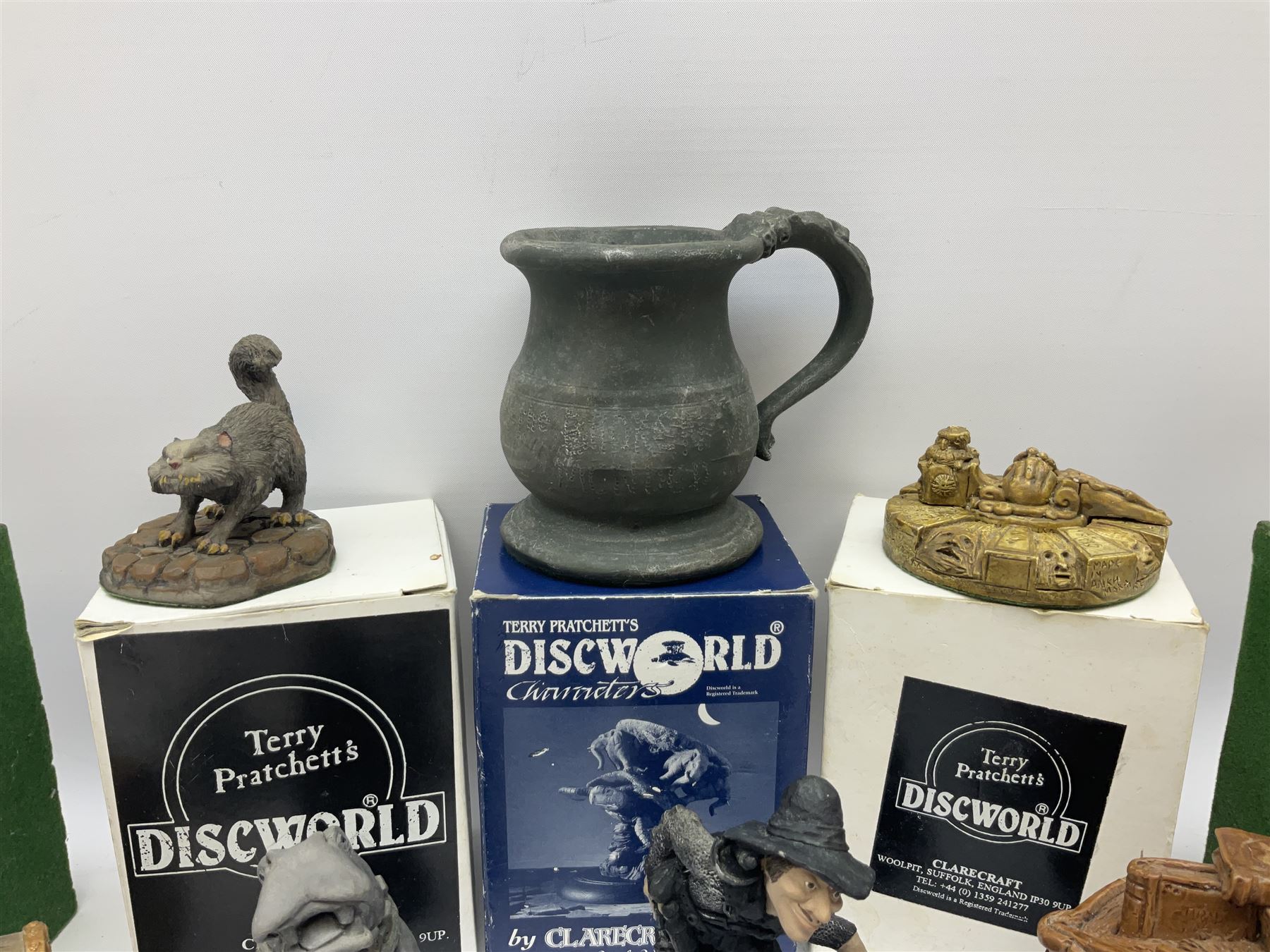 Terry Pratchett Discworld figures, comprising Roderick the hippo, DWE2, a 1995 event piece, Rincewind bookend, DW11, Death bookend, DW12, Librarians wizard knob, boxed, DW55, the luggage, boxed, DW04, tankard from the mended drum, DW21, Teppic the assassin, DW32, Greebo, DW45, Herne the hunted, DW64, Gaspode,  DW31, Quoth on skull, DW49 and Dibbler's compass DW16. 