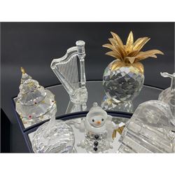 Large collection of Swarovski Crystal, to include pineapple, grapes, ships, musical instalments, Father Christmas, etc, together with stands  