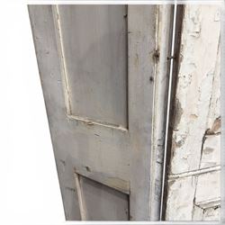 Set of three French 19th century painted pine folding window shutters of tall form, each comprising two hinged leaves with three graduated raised and fielded panels, in antique cream-painted finish
