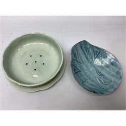 Clarice Cliff salad drainer and stand, moulded in relief with leaves and flowers on celadon ground, both with printed mark in green beneath, together with a studio pottery dish by Dennis Lucas, largest D22cm