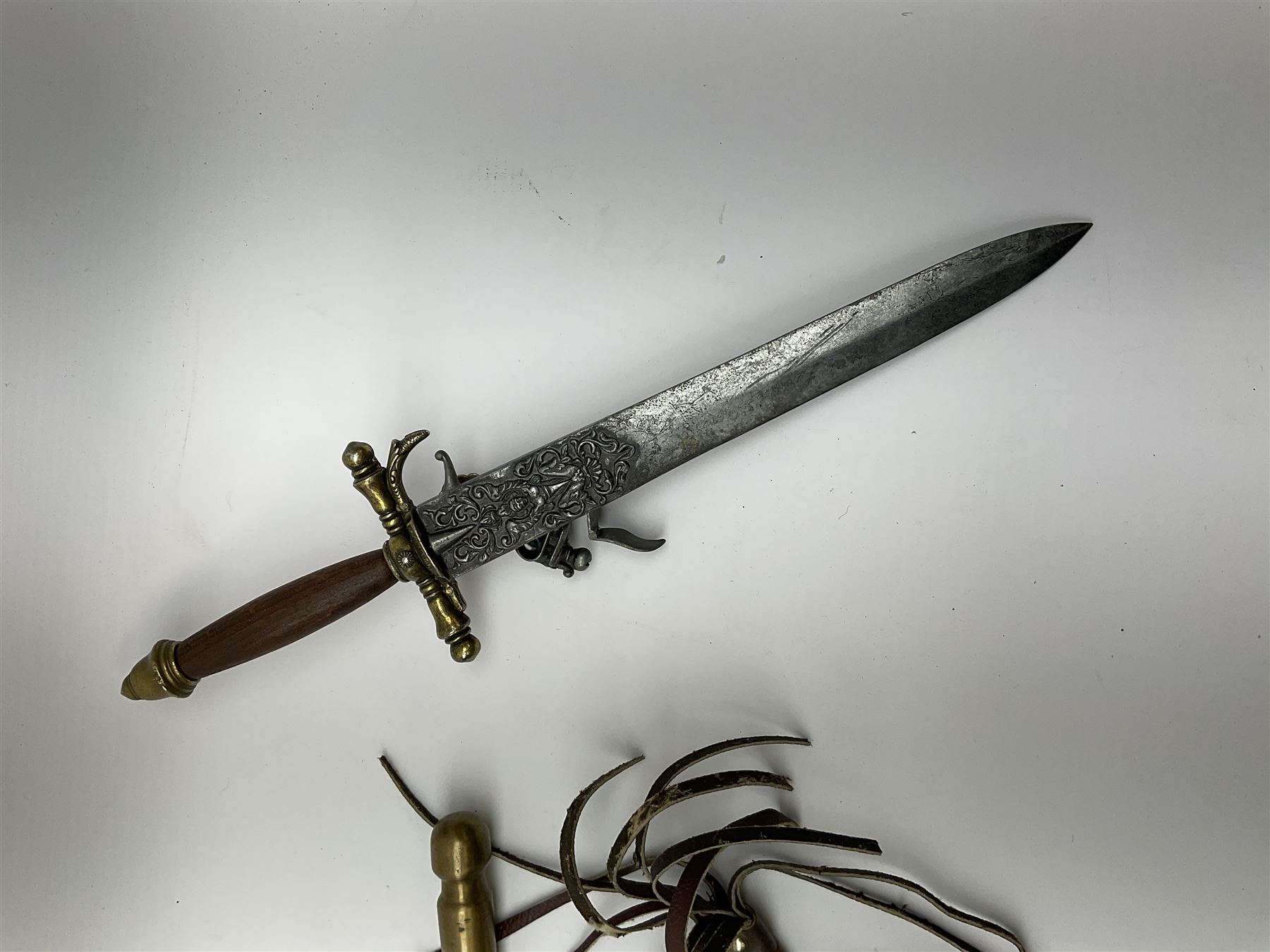 Guatemalan Collins & Co. reproduction machete with 61cm steel blade in tooled leather scabbard; modern bowie style knife, the 26cm pierced stainless steel blade with saw back and grained wooden grip in leather scabbard; and two reproduction daggers, one incorporating flintlock pistol (4)