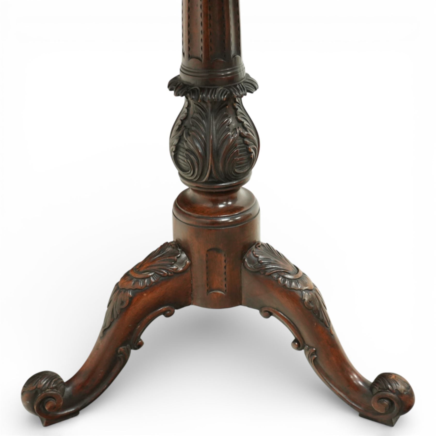 George III style carved mahogany kettle stand, the square top with gadrooned edge above a pull out slide, raised on a turned and carved baluster column issuing three carved cabriole legs terminating in scroll feet