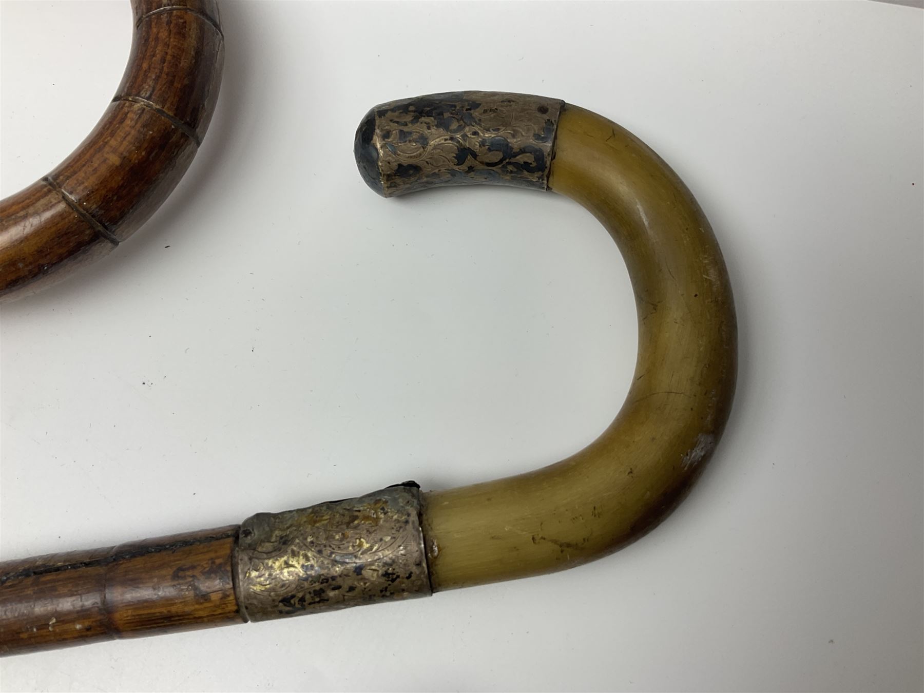 Early 20th century curved horn handle walking stick with hallmarked silver mounts, engraved L Russell 1918, together with a shooting stick by William Mills Birmingham, with leather handle, 'The Featherwaite' shooting stick and an umbrella with wooden handle